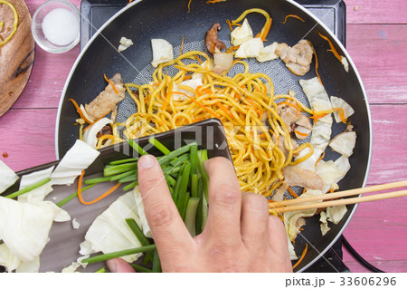Chef put slicing of spring onion for cooking 33606296