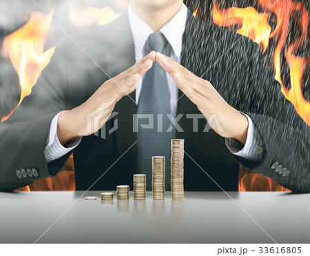 businessman hand cover money stack with fire businessman hand cover money stack with fire 33616805