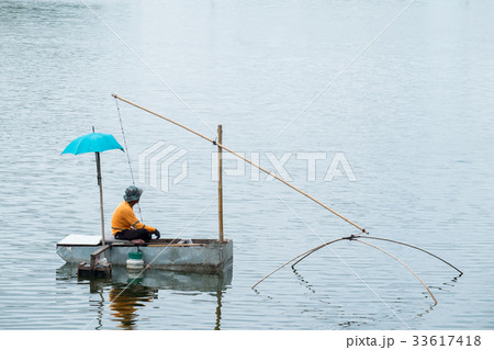 Asian fisherman fishing in the river morning. Asian fisherman fishing in the river morning. 33617418