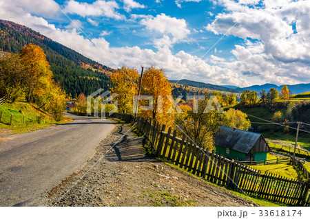 winding road through village in mountains 33618174