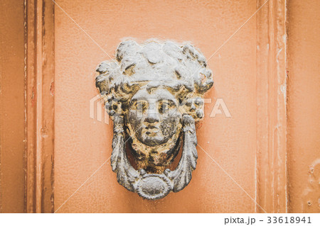 Old Metal Woman Head Knocker on Wooden door, Malta 33618941