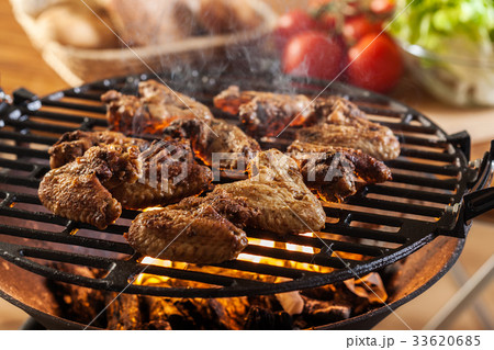 Grilling chicken wings on barbecue grill 33620685
