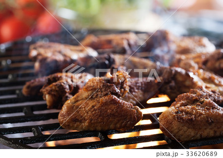Grilling chicken wings on barbecue grill Grilling chicken wings on barbecue grill 33620689