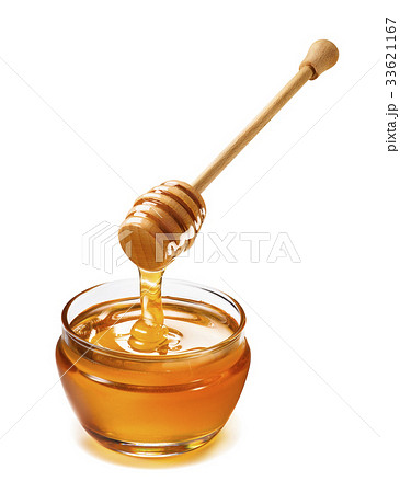 Glass jar and honey dripping from dipper isolated 33621167