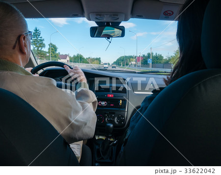 Driving a car, view from the back seat. 33622042
