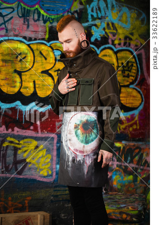 A creative, unusual red-haired man in designer 33622189