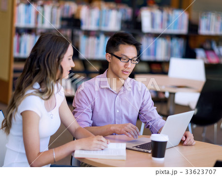 Two young students at the library 33623707