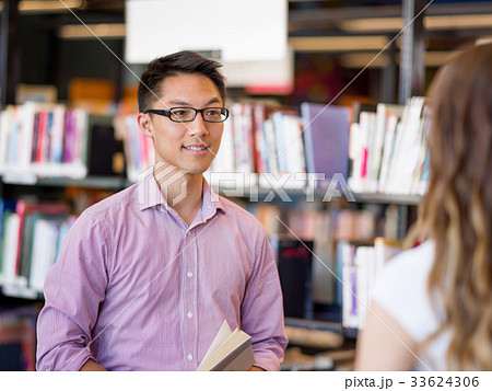 Two young students at the library 33624306