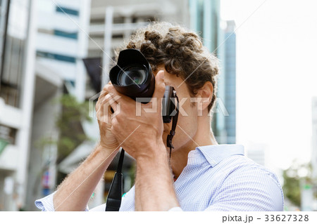 Male photographer taking picture 33627328