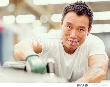Asian worker in production plant on the factory floor 33628599