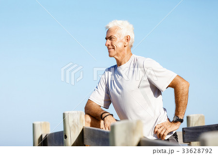 Man training on beach outside 33628792