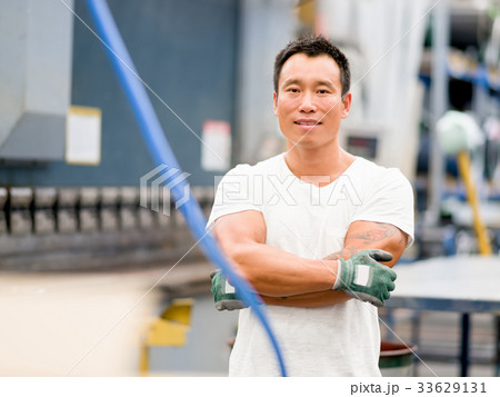 Asian worker in production plant on the factory floor 33629131