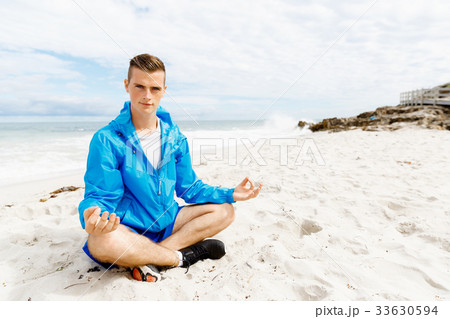 Man training on beach outside Man training on beach outside 33630594