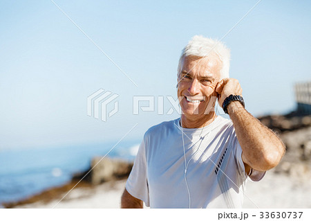 Sports and music. man getting ready for jogging Sports and music. man getting ready for jogging 33630737