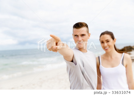 Couple of runners standing together on beach Couple of runners standing together on beach 33631074