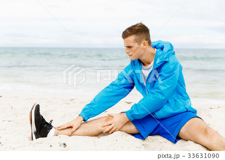 Man training on beach outside 33631090