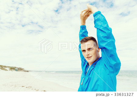 Man training on beach outside 33631327