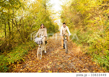Young couple in warm clothes cycling in autumn 33633449