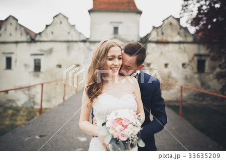 Happy wedding couple hugging and smiling each 33635209