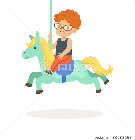 Cute little redhead boy riding on the carousel 33638668