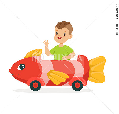 Cute little boy riding on toy fish car, kid have a 33638677