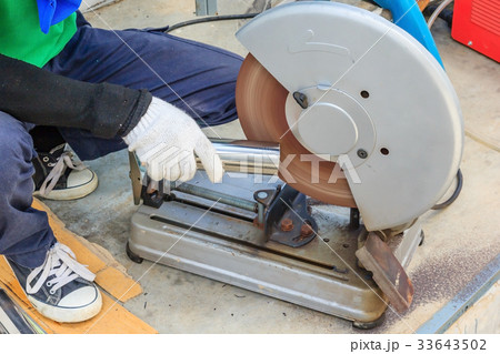 worker cutting metal with compound mitre saw 33643502