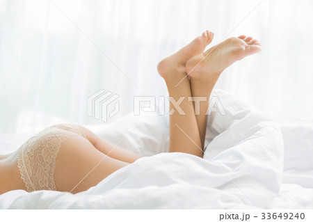 Buttock of a woman lying on her bed relaxed. 33649240