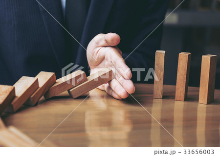 Close up of businessman hand Stopping Falling 33656003