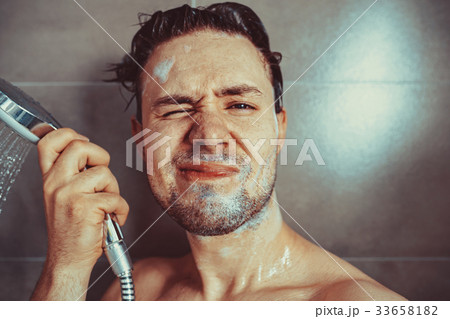 Young man washing head Young man washing head 33658182