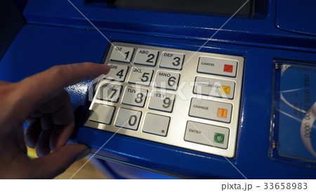 Blue color ATM machine and white button keypad. 33658983