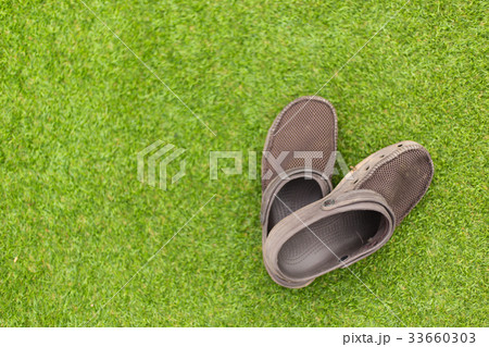 Brown sandals on green grass 33660303