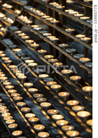 Candles in the church burn on a dark background  33660778