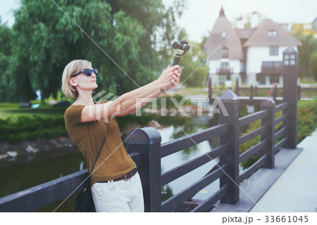 Woman capturing herself with personal camera 33661045