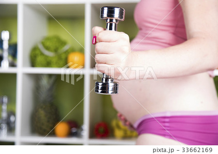 Pregnant Fitness Woman with dumbbells Pregnant Fitness Woman with dumbbells 33662169