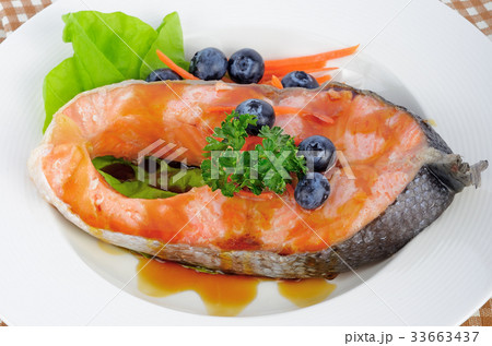 salmon steak with vegetables and fruit. 33663437