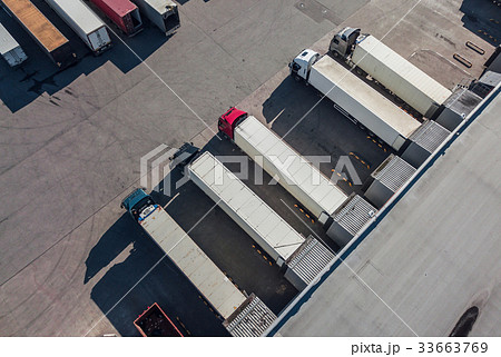Trucks unloading in logostics hub Trucks unloading in logostics hub 33663769