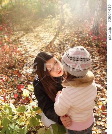 Two sisters in autumn forest Two sisters in autumn forest 33664419