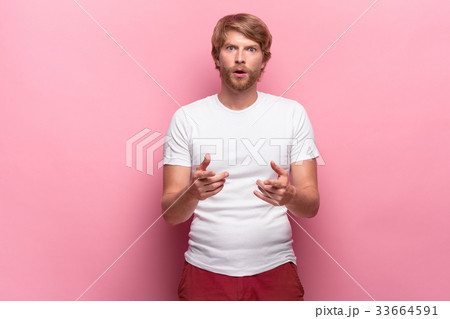 Portrait of young man with shocked facial 33664591