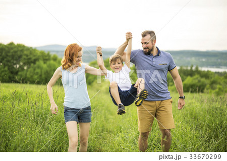 Mother father and daughter playing at the green 33670299