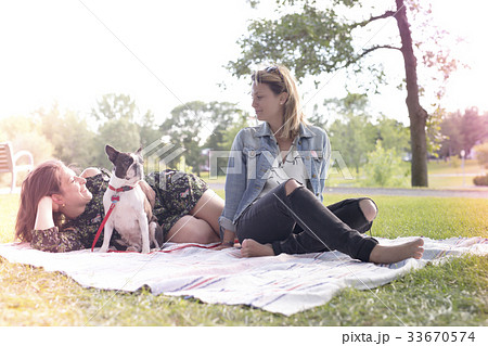 Two friends woman with terrier dog outside at the 33670574