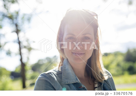 Young woman with long blond hair posing outside Young woman with long blond hair posing outside 33670576