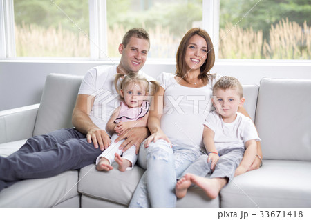 Beautiful family portrait sitting in the living 33671418