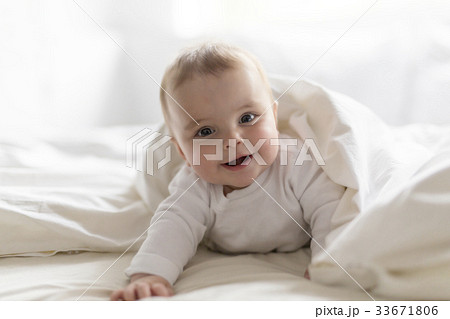 Cute happy 7 month baby girl in diaper lying and 33671806