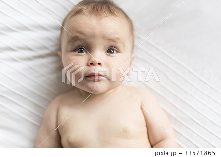 Cute happy 7 month baby girl in diaper lying and Cute happy 7 month baby girl in diaper lying and 33671865