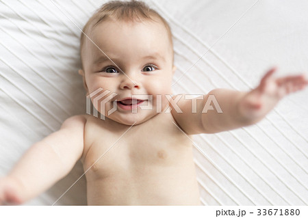 Cute happy 7 month baby girl in diaper lying and Cute happy 7 month baby girl in diaper lying and 33671880