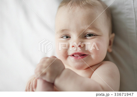 Cute happy 7 month baby girl in diaper lying and Cute happy 7 month baby girl in diaper lying and 33671947