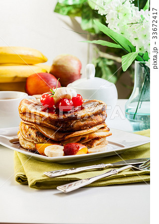 Pancakes with chocolate sauce fruit and coffee Pancakes with chocolate sauce fruit and coffee 33672417