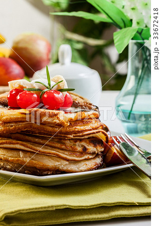 Pancakes with chocolate sauce fruit and coffee Pancakes with chocolate sauce fruit and coffee 33672418