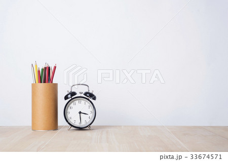 alarm clock and pencil on wood table  33674571