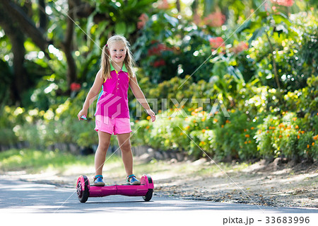 Child on hover board. Kids ride scooter. 33683996